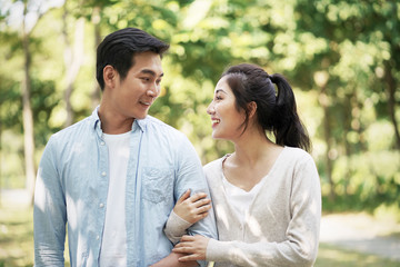 young asian couple relaxing outdoors