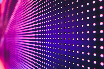 Bright colored blue LED wall with pink pattern - close up background.