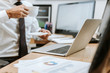 © LIGHTFIELD STUDIOS - cropped view of bi-racial trader sitting at table and holding cup