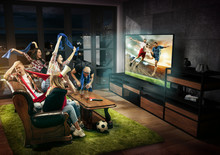 Group Of Friends Watching TV, Football Match, Sport Together. Emotional Men And Women Cheering For Favourite Team, Look On Goal And Fighting For Ball. Concept Of Friendship, Leisure Activity, Emotions
