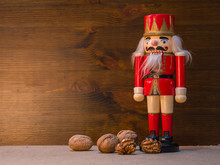 Vintage Christmas Soldier Nutcracker With Walnuts On A Wooden Background.