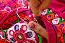 Female Needlework On Fabric Material Close Up View,Unidentified Tribal Women Sewing Ethnic Dresses,ahir Embroidery Art Work Close Up View,Gujarat India  Embroidery
