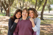 © rzcreative/Stocksy - Three generations of related women smiling and embracing one another while standing outside.