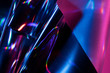 © Robert Kohlhuber/Stocksy - Reflection of light on holographic foils with neon lighting