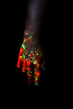 Male Hand Painted With Fluorescent Paint Glowing In The Darkness
