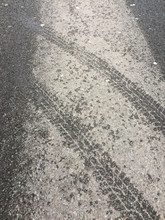 Tire Tracks On Asphalt Road