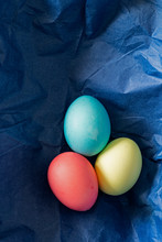 Colorful Easter Eggs Nestled In Blue Paper