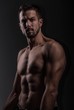 © John Ilich - Muscular Male Fitness Model in Dark Gym Lighting – Defined Abs, Strong Upper Body, Athletic Physique for Bodybuilding, Workout and Health Advertising