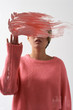 © Clique Images/Stocksy - Young woman with face covered behind smear