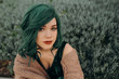 © Isaiah & Taylor Photography/Stocksy - Portrait of young beautiful woman wearing a glamorous green costume wig and red lipstick