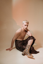 Fashionable Gay Man In Boots And Skirt