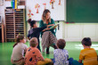 © ALTO IMAGES/Stocksy - Young teacher and her students in the classroom