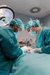 © Santi Nunez/Stocksy - Team of Surgeons Operating in the Hospital