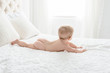 © Alison Winterroth Photography/Stocksy - A Little Baby's Bottom On A Simple Bed