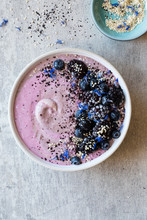Breakfast Smoothie Topped With Berries, Acai Berry Powder, Toasted Sesame Seeds