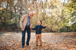 © Sanja - A grandson going on his first adventure in nature with his grandfather. It's a wonderful day in autumn and they are strolling, talking and holding each other's hands.
