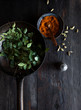 © Nadine Greeff/Stocksy - Fresh green curry leaves, cardamom seeds and curry spice