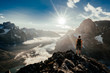© Chris Zielecki/Stocksy - Man on rocky cliff above amazing valley