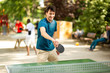 © mimagephotos - happy young man playing table tennis in park