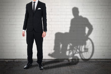 Businessman Standing With Shadow Of A Disables Man