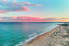 Picturesque Scenery Aerial Drone View Landscape, Calm Blue Mediterranean Sea Colourful Fluffy Glowing Pink Clouds At Sunset Evening Sky, Sandy Coastline. La Mata, Torrevieja, Costa Blanca, Spain