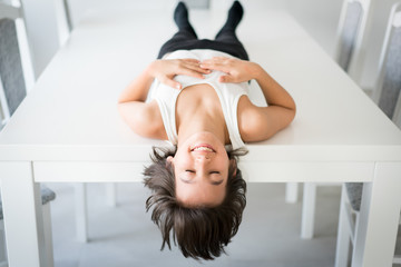 Wall Mural - Happy kid lying on table at home