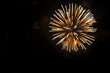 © Michal Murawski - White and yellow fireworks in the shape sphere on the right side on a black background.