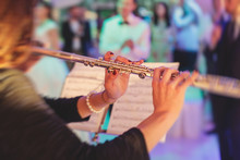 Concert View Of A Flutist Flute Player With Musical Jazz Band And Audience In The Background