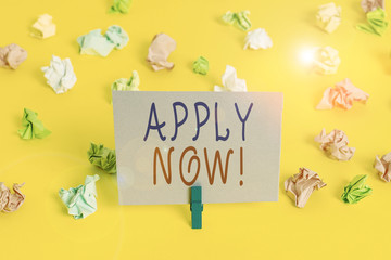 Conceptual hand writing showing Apply Now. Concept meaning request something officially in writing or by sending in form Colored crumpled paper empty reminder white floor clothespin