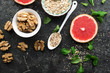 © annaileish - Ingredients for a healthy breakfast, nuts, oatmeal, honey, berries, fruits, blueberry, orange, pomegranate seeds, almonds, walnuts. The concept of natural organic food in season. Top view