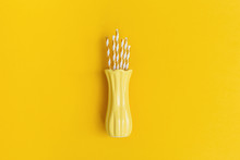 Minimal Composition Yellow Colored With Paper Drinking Straws Inside Ceramic Vase. Creative Trendly Concept For Holiday, Birthday Greeting Card. Top View And Flat Lay.