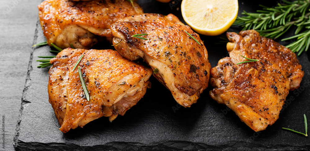 Grilled chicken thighs with spices and lemon.  - obrazy, fototapety, plakaty 