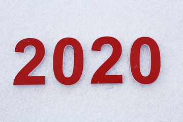 Aufkleber - The red numbers 2020 lie on the white snow as a symbol of the coming new year.