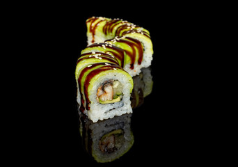 Wall Mural - sushi and rolls with different fillings on a black background with reflection