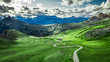 Winding road in Passo Giau and green Dolomites, aerial view