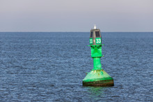 Green Lateral Buoy At The Edge Of A Fairway