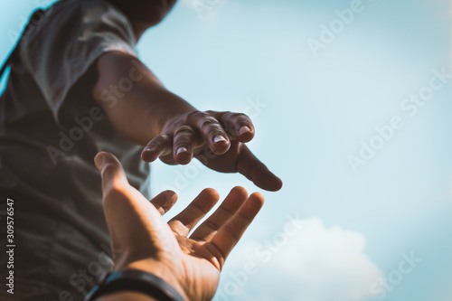 Cuadros en Lienzo Help Concept hands reaching out to help each other in dark tone.