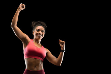 Wall Mural - Cheerful fitness model raising her hands up, celebrating success