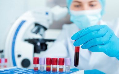 Poster - Blurred Woman in mask and gloves choosing blood sample