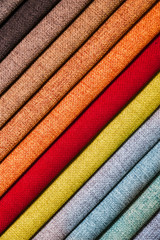 Wall Mural - Colorful and bright fabric samples of furniture and clothing upholstery. Close-up of a palette of textile abstract diagonal stripes of different colors