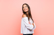 © luismolinero - Young woman over isolated pink background with arms crossed and happy