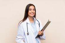 Young Doctor Woman Over Isolated Background Holding A Folder