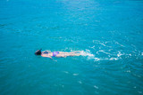 Fototapeta Łazienka - Young woman in bikini snorkeling