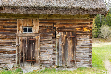 Wall Mural - Old weathered timber barn with a thatched roof