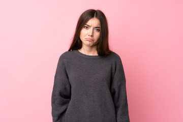 Wall Mural - Young woman over isolated pink background with sad and depressed expression