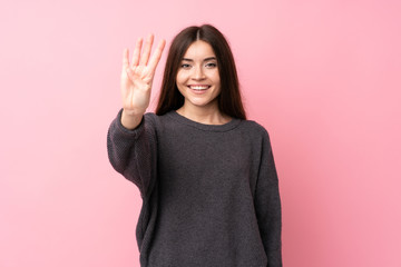 Wall Mural - Young woman over isolated pink background happy and counting four with fingers