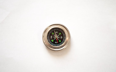 compass in a metal frame on a white background. view from above.