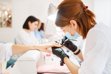 group of women on manicure procedure, beauty salon