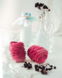 Handmade air russian fruit pink marshmallow on a white background with beautiful bottles and dry berries. Homemade Sweets.
