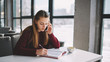 © GalakticDreamer - Beautiful women talking by mobile phone for consultation with service operator,young female calling to friend in break of studying using modern smartphone and writing time of meeting in notebook